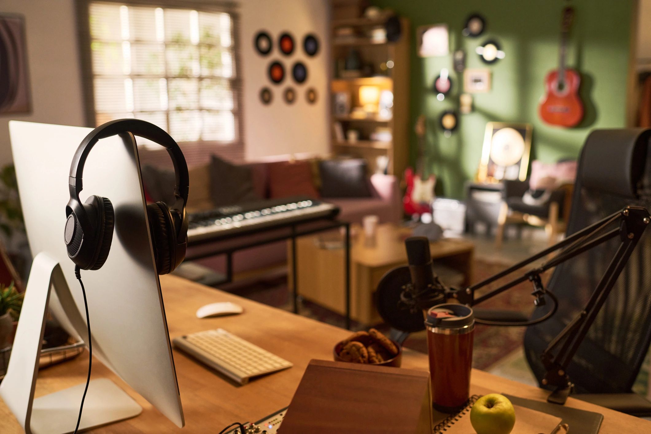 Podcast studio setup with microphone, headphones, and recording equipment